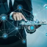 Man in suit holding model of futuristic interconnected city